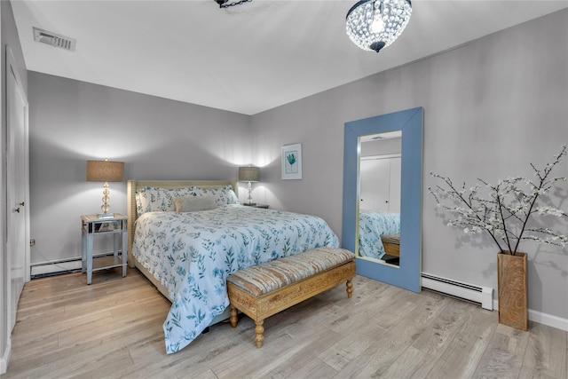 123 Maple Ave, Northport, NY 11768 - bedroom with baseboard heating and wood finished floors