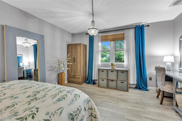 123 Maple Ave, Northport, NY 11768 - bedroom with a chandelier and light wood-style floors