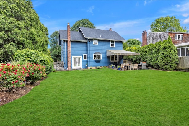 123 Maple Ave, Northport, NY 11768 - rear view of house with french doors and a chimney