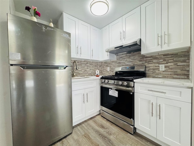 132-49 41st Rd Unit 2A, Flushing, NY 11355 - kitchen with appliances with stainless steel finishes, under cabinet range hood, a sink, light wood-style floors, and tasteful backsplash