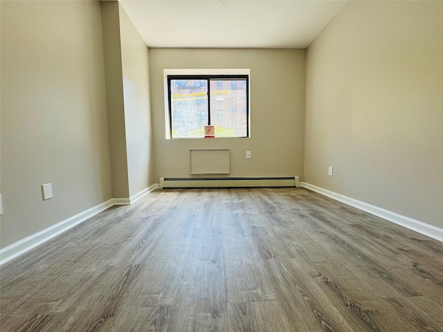 132-49 41st Rd Unit 2A, Flushing, NY 11355 - spare room with a baseboard radiator, wood finished floors, and baseboards