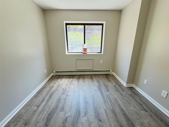 132-49 41st Rd Unit 2A, Flushing, NY 11355 - unfurnished room featuring baseboard heating, wood finished floors, and baseboards