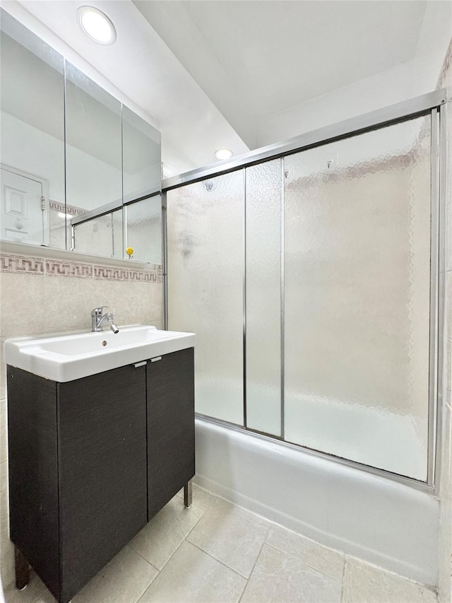81-11 45th Ave Unit 3R, Elmhurst, NY 11373 - full bath featuring vanity, shower / bath combination with glass door, tile patterned flooring, tile walls, and recessed lighting