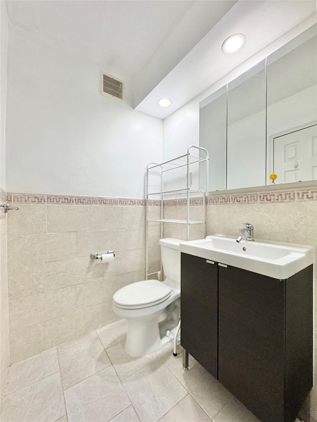 81-11 45th Ave Unit 3R, Elmhurst, NY 11373 - bathroom with tile walls, toilet, vanity, tile patterned flooring, and recessed lighting