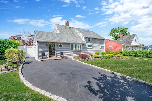 51 Pewter Ln, Hicksville, NY 11801 - rear view of property featuring driveway, roof with shingles, a chimney, and a gate