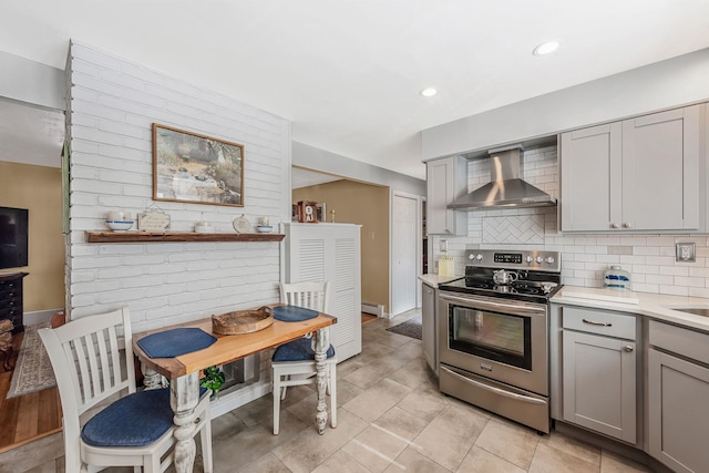 51 Pewter Ln, Hicksville, NY 11801 - kitchen with wall chimney exhaust hood, stainless steel electric range oven, gray cabinets, light countertops, and backsplash