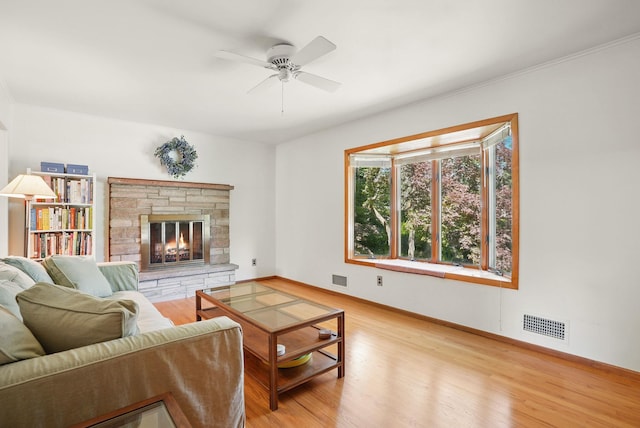 7 Adele Ct, Montrose, NY 10567 - living area with light wood-type flooring, a ceiling fan, a fireplace, and baseboards