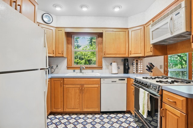 7 Adele Ct, Montrose, NY 10567 - kitchen featuring white appliances, a sink, healthy amount of natural light, and light countertops