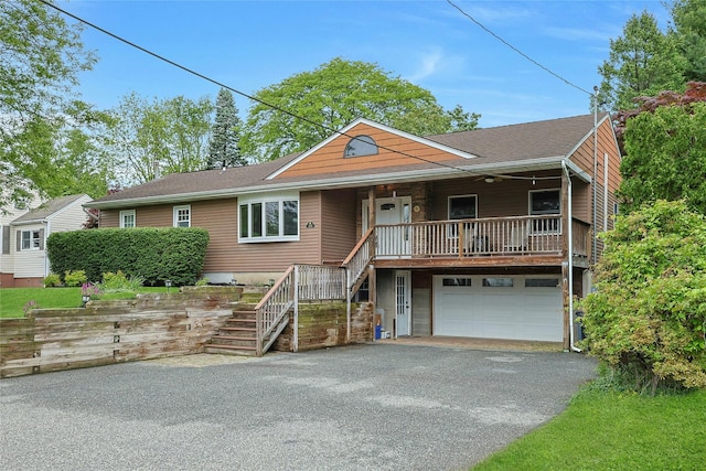 29 Jackson Dr, Stony Point, NY 10980 - view of front of home featuring stairs, asphalt driveway, a garage, covered porch, and a shingled roof