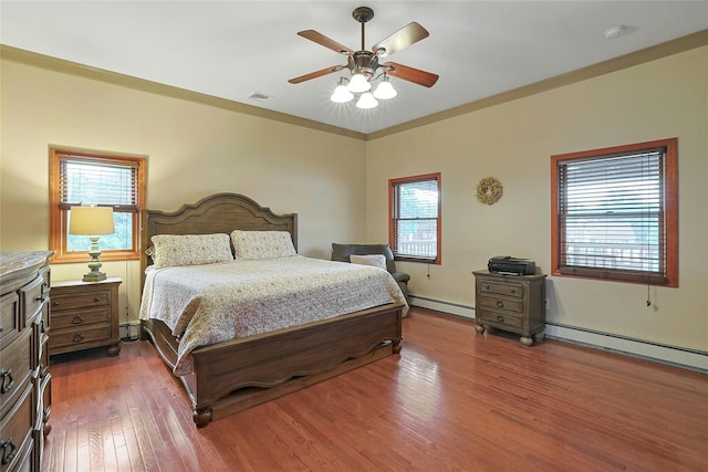 29 Jackson Dr, Stony Point, NY 10980 - bedroom featuring a baseboard heating unit, dark wood-type flooring, and a ceiling fan