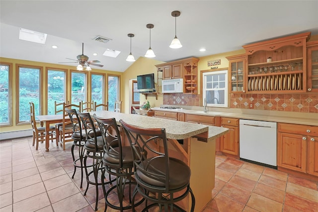 29 Jackson Dr, Stony Point, NY 10980 - kitchen featuring white appliances, open shelves, a skylight, light countertops, and a kitchen breakfast bar