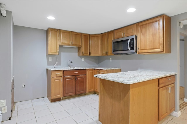 29 Jackson Dr, Stony Point, NY 10980 - kitchen with stainless steel microwave, a sink, light tile patterned flooring, recessed lighting, and brown cabinetry