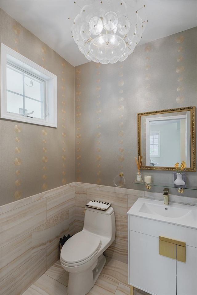 2740 Netherland Ave, Bronx, NY 10463 - bathroom with tile walls, toilet, vanity, and wainscoting