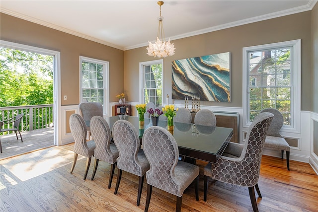 2740 Netherland Ave, Bronx, NY 10463 - dining room featuring a chandelier, wood finished floors, wainscoting, ornamental molding, and a decorative wall