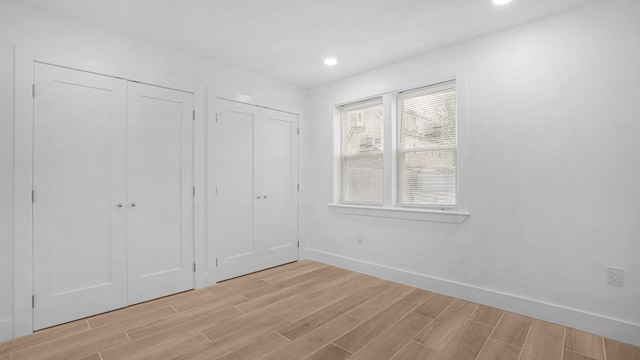 3964 Duryea Ave, Bronx, NY 10466 - unfurnished bedroom with light wood-style flooring, baseboards, multiple closets, and recessed lighting