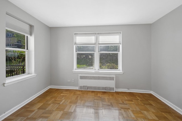 162-21 Powells Cove Blvd Unit 1M, Beechhurst, NY 11357 - unfurnished room with radiator, plenty of natural light, and baseboards