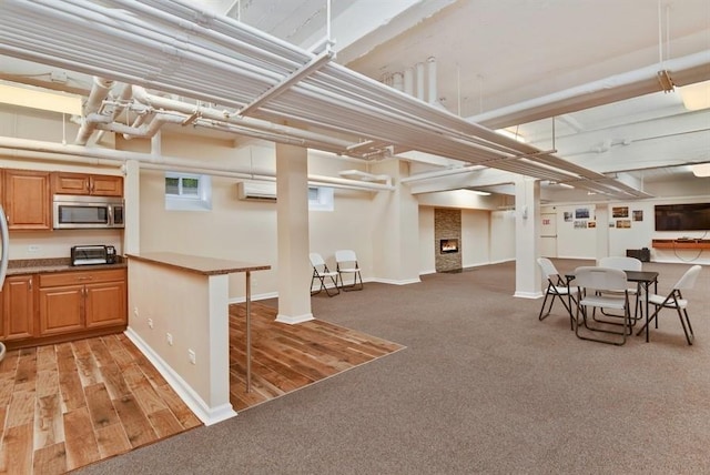162-21 Powells Cove Blvd Unit 1M, Beechhurst, NY 11357 - kitchen featuring stainless steel microwave, open floor plan, light colored carpet, and baseboards
