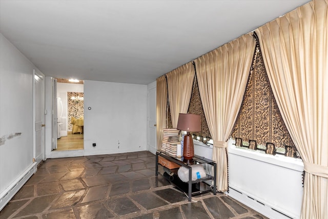 725 Clinton St, Westbury, NY 11590 - living area with baseboard heating and baseboards