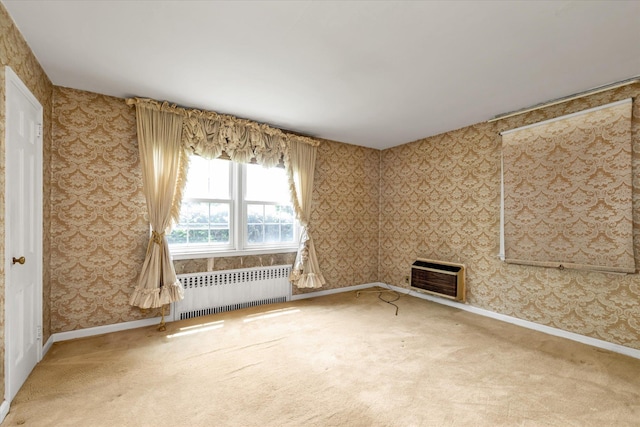 725 Clinton St, Westbury, NY 11590 - spare room featuring radiator heating unit, wallpapered walls, carpet flooring, baseboards, and heating unit