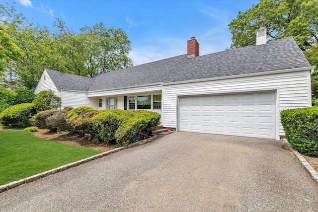 725 Clinton St, Westbury, NY 11590 - view of front of home featuring driveway, an attached garage, a front lawn, and a shingled roof