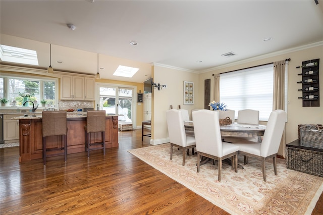 14 Merritts Rd, Farmingdale, NY 11735 - dining area with dark wood finished floors, a skylight, crown molding, baseboards, and recessed lighting