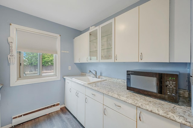 2453 Union Blvd Unit 37A, Islip, NY 11751 - kitchen featuring a sink, a baseboard radiator, black microwave, wood finished floors, and baseboards