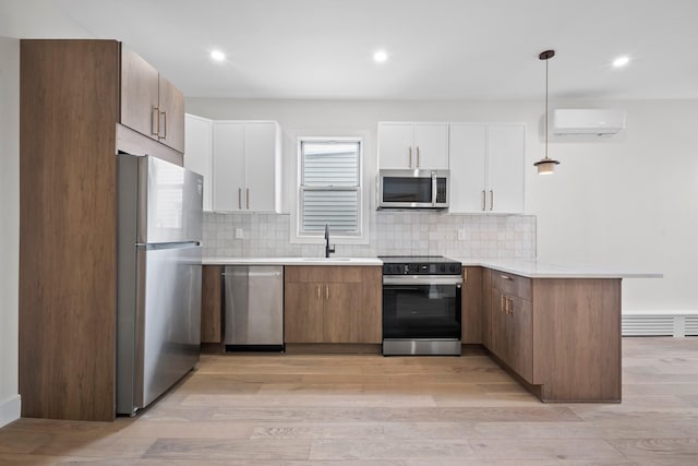 14-09 131st St, College Point, NY 11356 - kitchen with stainless steel appliances, a peninsula, light countertops, light wood-type flooring, and recessed lighting