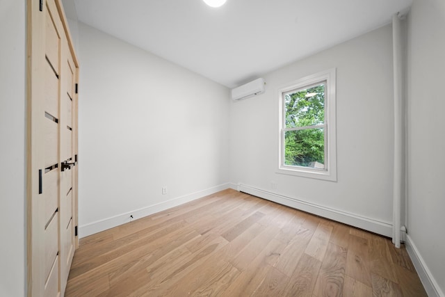 14-09 131st St, College Point, NY 11356 - empty room with baseboard heating, a wall unit AC, light wood-style flooring, and baseboards