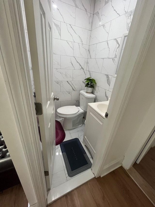 17363 105th Ave, Jamaica, NY 11433 - bathroom with vanity, toilet, wood finished floors, and tile walls