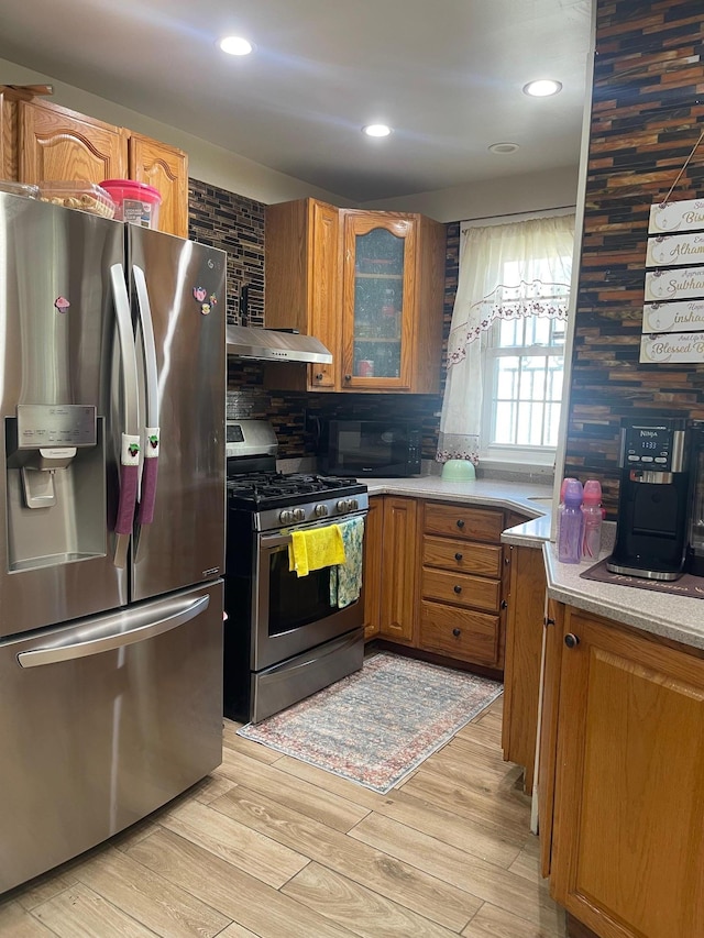 17363 105th Ave, Jamaica, NY 11433 - kitchen featuring appliances with stainless steel finishes, brown cabinetry, tasteful backsplash, glass insert cabinets, and recessed lighting