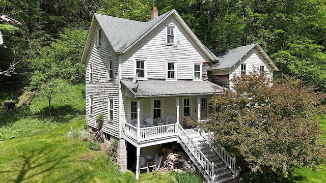 12 Henderson Rd, Hankins, NY 12741 - view of front of house with a shingled roof, stairs, a porch, a front lawn, and a wooded view