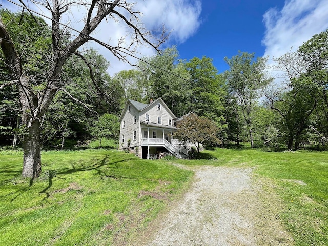 12 Henderson Rd, Hankins, NY 12741 - view of front of property featuring stairway, driveway, a porch, a front yard, and a view of trees
