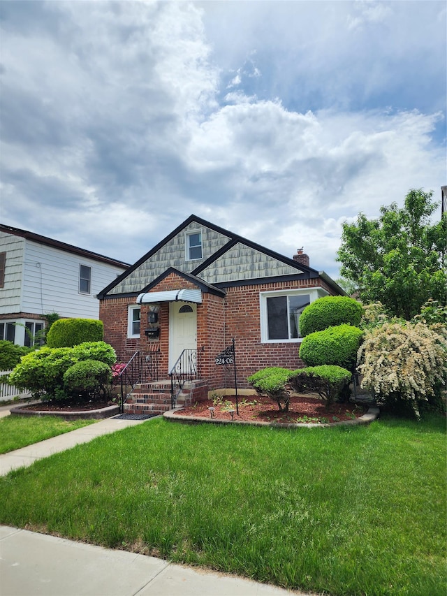 224-06 114th Rd, Cambria Heights, NY 11411 - view of front of house with a front yard and brick siding