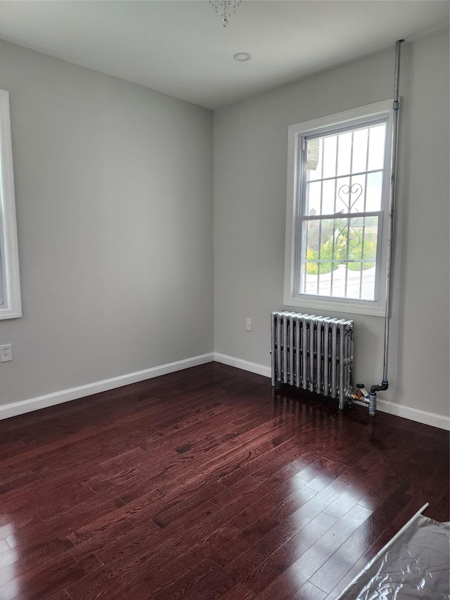 224-06 114th Rd, Cambria Heights, NY 11411 - empty room featuring radiator heating unit, hardwood / wood-style floors, and baseboards