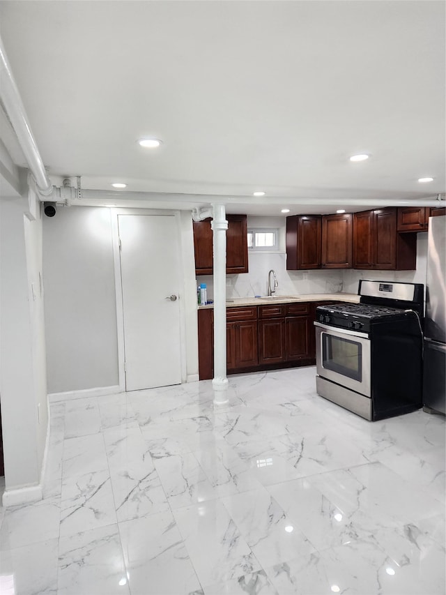 224-06 114th Rd, Cambria Heights, NY 11411 - kitchen with stainless steel range with gas stovetop, a sink, recessed lighting, freestanding refrigerator, and light countertops