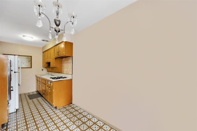 7345 53rd Rd, Maspeth, NY 11378 - kitchen with light countertops, light floors, a sink, tasteful backsplash, and freestanding refrigerator
