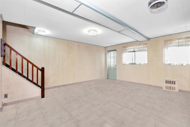 7345 53rd Rd, Maspeth, NY 11378 - basement with plenty of natural light, wood walls, stairway, and tile patterned floors