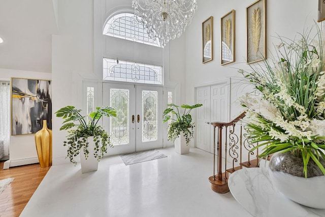 8 Stark Ct, New City, NY 10956 - entryway with a high ceiling, a chandelier, a baseboard heating unit, french doors, and stairs