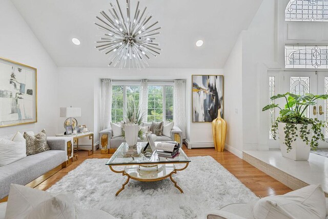 8 Stark Ct, New City, NY 10956 - living area featuring a chandelier, high vaulted ceiling, recessed lighting, baseboard heating, and wood finished floors