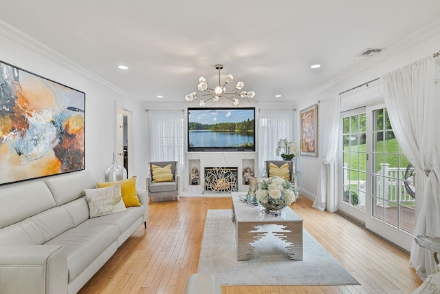 8 Stark Ct, New City, NY 10956 - living area featuring light wood-type flooring, a chandelier, a lit fireplace, ornamental molding, and recessed lighting
