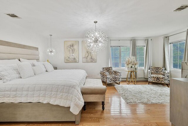 8 Stark Ct, New City, NY 10956 - bedroom with a chandelier, multiple windows, and wood finished floors