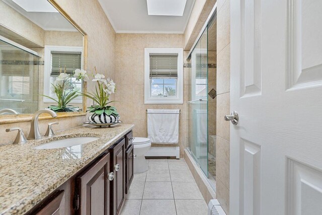 8 Stark Ct, New City, NY 10956 - bathroom featuring vanity, toilet, a skylight, a stall shower, and tile patterned flooring