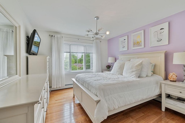 8 Stark Ct, New City, NY 10956 - bedroom with a chandelier, light wood-style floors, and a baseboard heating unit