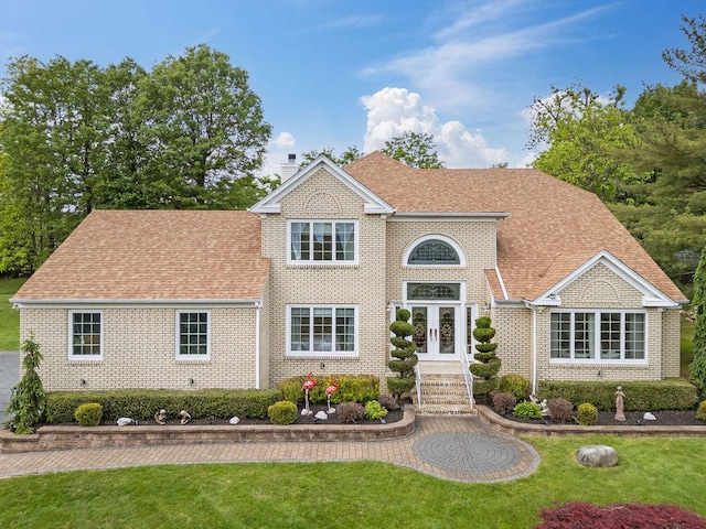 8 Stark Ct, New City, NY 10956 - view of front of house featuring french doors, brick siding, a front yard, and a chimney