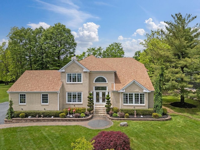 8 Stark Ct, New City, NY 10956 - view of front facade featuring french doors, brick siding, a front yard, and a chimney