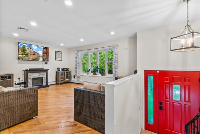 294 Rte 292, Holmes, NY 12531 - living area featuring light wood-style floors, a chandelier, recessed lighting, and a stone fireplace