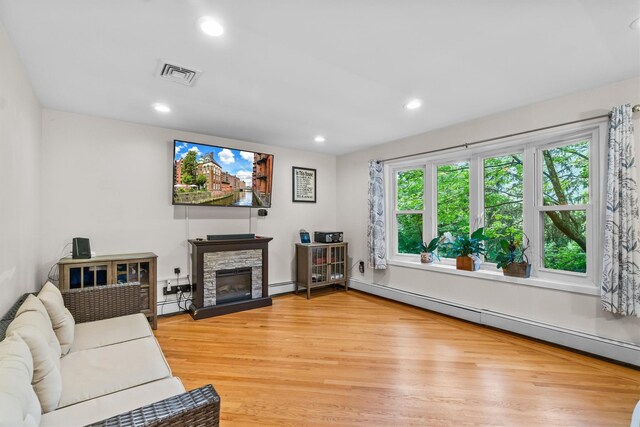 294 Rte 292, Holmes, NY 12531 - living area with light wood-style floors, a baseboard heating unit, recessed lighting, a stone fireplace, and baseboard heating
