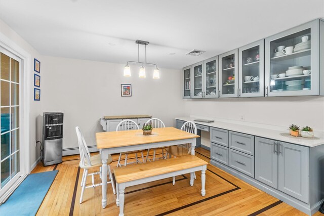 294 Rte 292, Holmes, NY 12531 - dining space featuring light wood finished floors and a baseboard heating unit