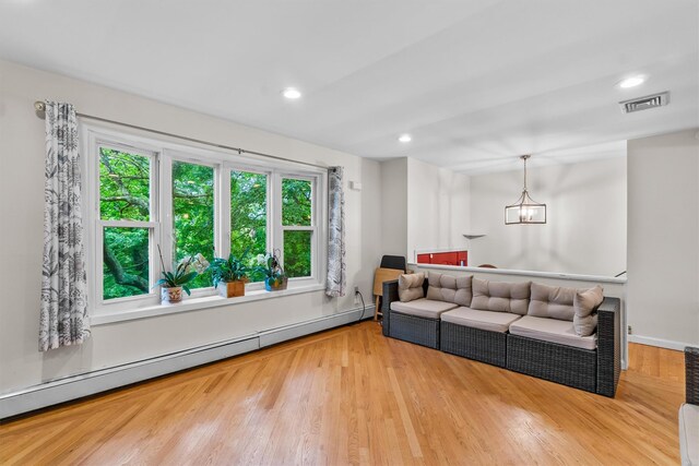 294 Rte 292, Holmes, NY 12531 - living room with baseboard heating, wood finished floors, recessed lighting, and a chandelier