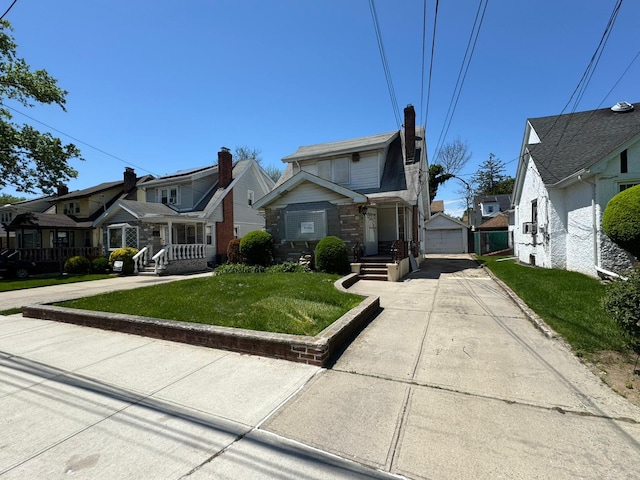 186-39 Ilion Ave, Saint Albans, NY 11412 - view of front of property with a residential view, a garage, a front lawn, and concrete driveway